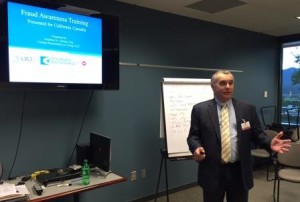 Insurance fraud attorney Jon Colman teaches a seminar.